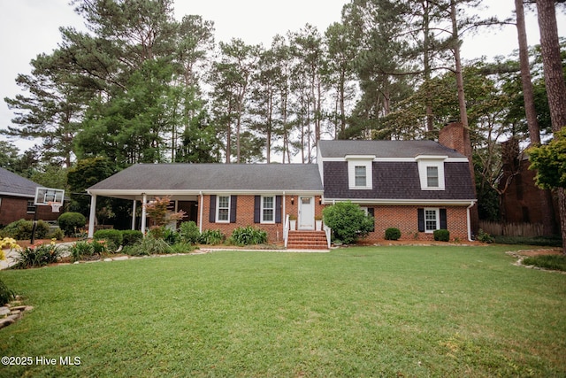 1103 Greenbriar Rd NW, Wilson, NC 27896 - view of front of house featuring brick siding, a chimney, and a shingled roof