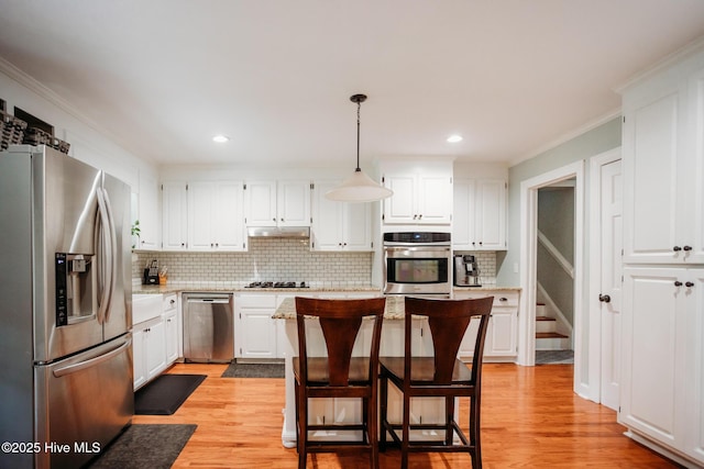 1103 Greenbriar Rd NW, Wilson, NC 27896 - kitchen featuring stainless steel appliances, tasteful backsplash, crown molding, white cabinets, and light wood-type flooring