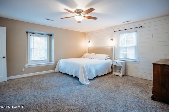 1103 Greenbriar Rd NW, Wilson, NC 27896 - carpeted bedroom featuring ceiling fan and wood walls