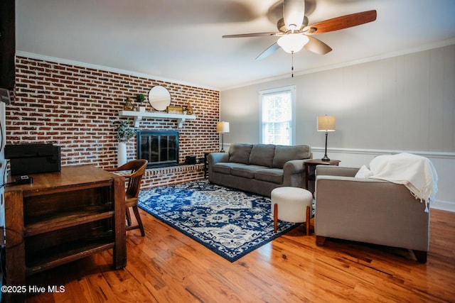 1103 Greenbriar Rd NW, Wilson, NC 27896 - living room with wood finished floors, a ceiling fan, brick wall, ornamental molding, and a brick fireplace