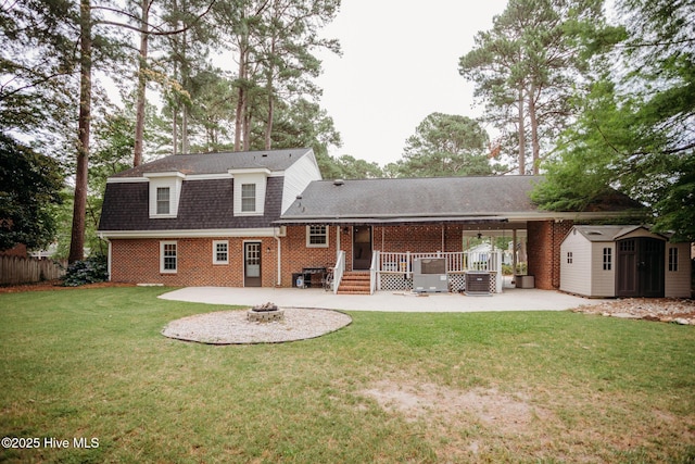 1103 Greenbriar Rd NW, Wilson, NC 27896 - back of house featuring a fire pit, a patio, a shed, brick siding, and roof with shingles