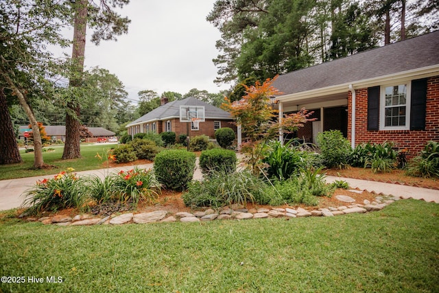 1103 Greenbriar Rd NW, Wilson, NC 27896 - view of front of property with a front yard, brick siding, and roof with shingles