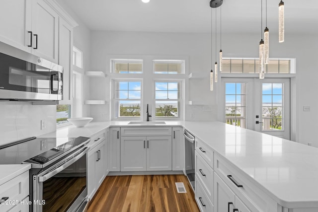 316 Bettie Path Rd, Beaufort, NC 28516 - kitchen with appliances with stainless steel finishes, a sink, wood finished floors, and healthy amount of natural light