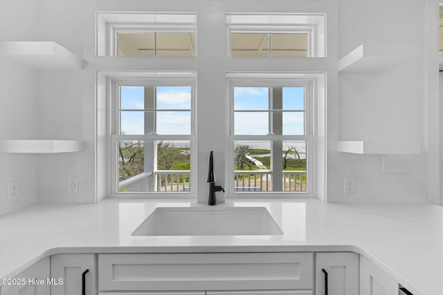 316 Bettie Path Rd, Beaufort, NC 28516 - kitchen with a sink, plenty of natural light, white cabinets, and light countertops