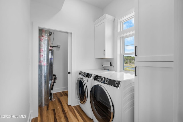 316 Bettie Path Rd, Beaufort, NC 28516 - washroom with washer and dryer, cabinet space, wood finished floors, and plenty of natural light