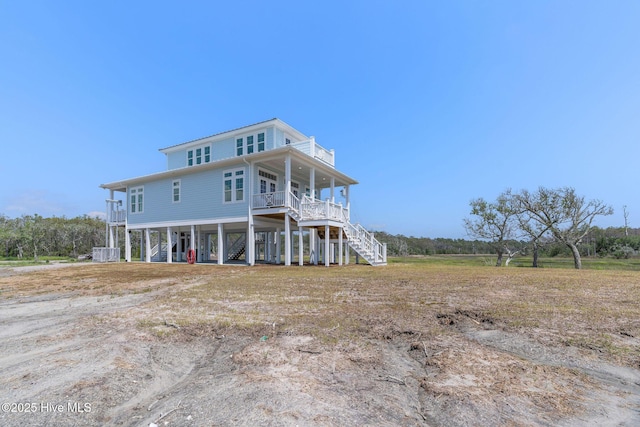316 Bettie Path Rd, Beaufort, NC 28516 - back of house featuring stairway, a carport, a porch, and central AC