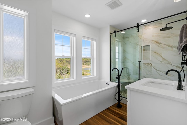 316 Bettie Path Rd, Beaufort, NC 28516 - bathroom featuring a freestanding tub, wood finished floors, a marble finish shower, toilet, and vanity