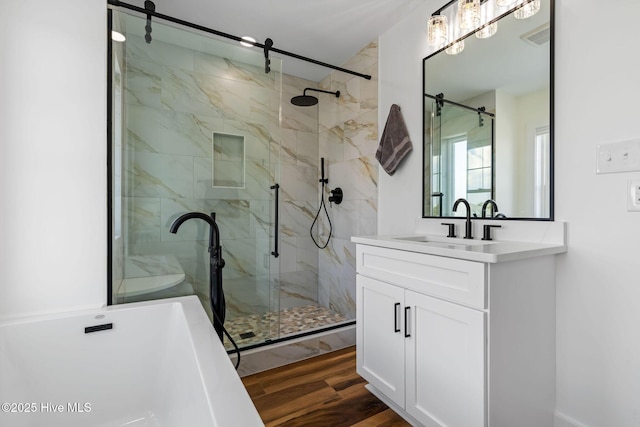 316 Bettie Path Rd, Beaufort, NC 28516 - bathroom with a freestanding tub, a marble finish shower, vanity, and wood finished floors