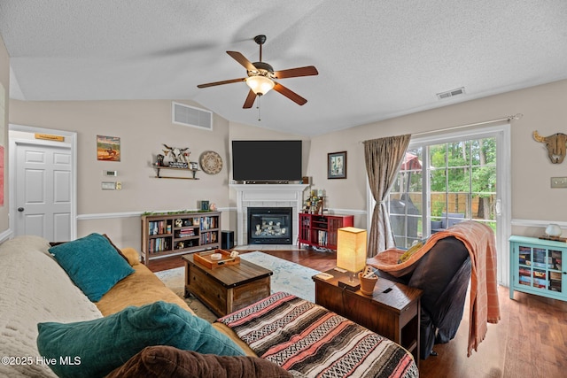 302 Fairmount Way, New Bern, NC 28562 - living area featuring wood finished floors, a ceiling fan, lofted ceiling, a textured ceiling, and a fireplace