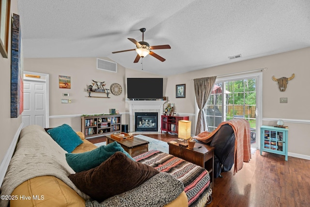 302 Fairmount Way, New Bern, NC 28562 - living area featuring a ceiling fan, a textured ceiling, wood finished floors, vaulted ceiling, and a tiled fireplace