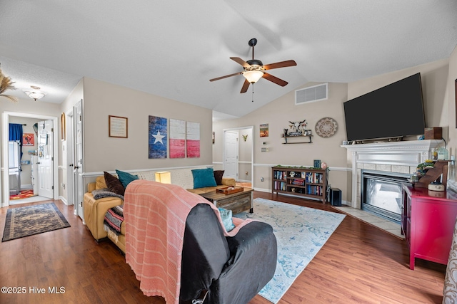 302 Fairmount Way, New Bern, NC 28562 - living area featuring a ceiling fan, wood finished floors, a tiled fireplace, and vaulted ceiling