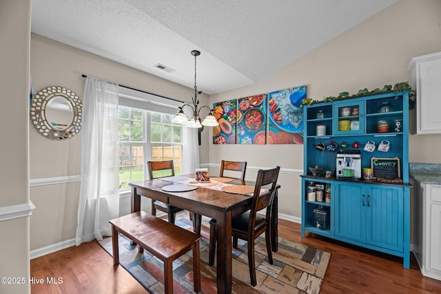 302 Fairmount Way, New Bern, NC 28562 - dining area featuring a chandelier, wood finished floors, a textured ceiling, and lofted ceiling