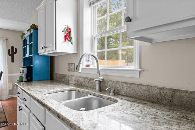 302 Fairmount Way, New Bern, NC 28562 - kitchen featuring white cabinetry, a textured ceiling, and light stone countertops