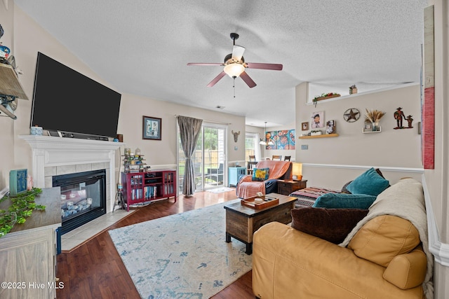 302 Fairmount Way, New Bern, NC 28562 - living room with ceiling fan, a textured ceiling, wood finished floors, and a tile fireplace