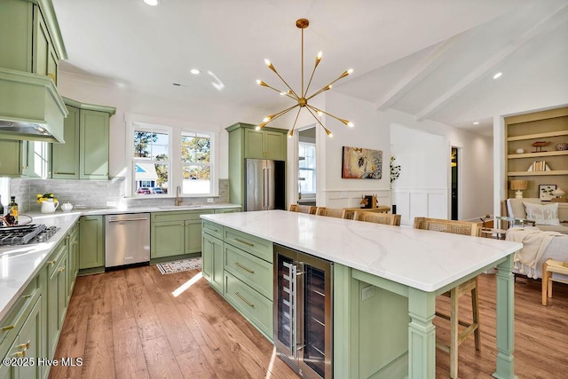 3810 River Park Way NE, Leland, NC 28451 - kitchen with green cabinetry, beverage cooler, appliances with stainless steel finishes, a kitchen bar, and a kitchen island