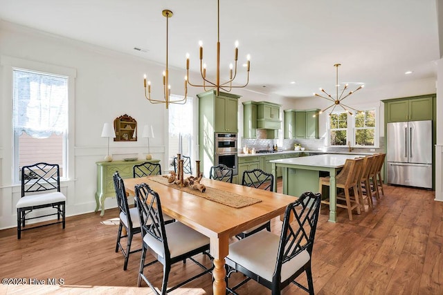 3810 River Park Way NE, Leland, NC 28451 - dining space featuring a chandelier, light wood-style flooring, crown molding, and recessed lighting