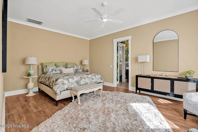 3810 River Park Way NE, Leland, NC 28451 - bedroom with wood finished floors, crown molding, baseboards, a walk in closet, and a ceiling fan