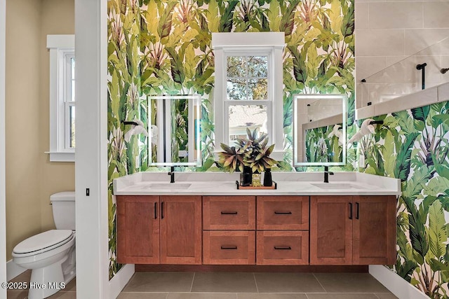 3810 River Park Way NE, Leland, NC 28451 - full bathroom with toilet, double vanity, wallpapered walls, baseboards, and tile patterned flooring
