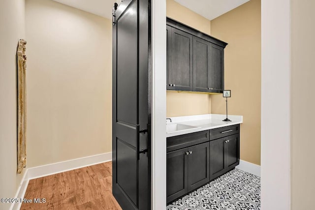 3810 River Park Way NE, Leland, NC 28451 - interior space featuring baseboards, a sink, and light wood-style flooring