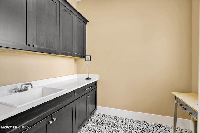 3810 River Park Way NE, Leland, NC 28451 - washroom with a sink, baseboards, and light tile patterned flooring