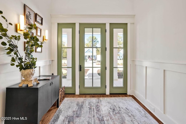 3810 River Park Way NE, Leland, NC 28451 - doorway to outside with wood finished floors, wainscoting, and a decorative wall