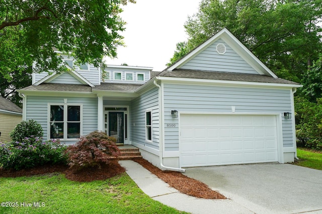 8500 Hammock Dunes Dr, Wilmington, NC 28411 - view of front of house with roof with shingles, driveway, and an attached garage