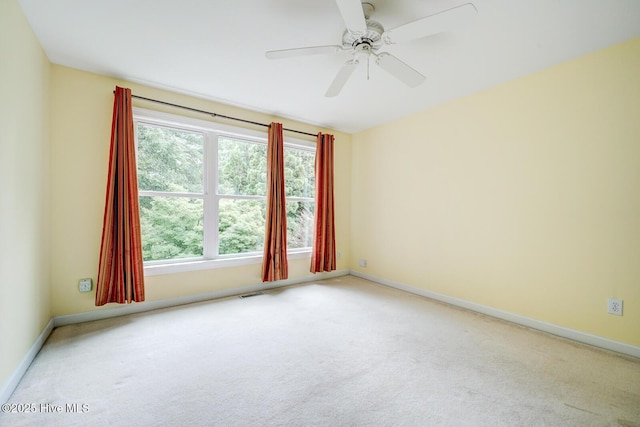 8500 Hammock Dunes Dr, Wilmington, NC 28411 - empty room featuring light carpet, baseboards, and a ceiling fan