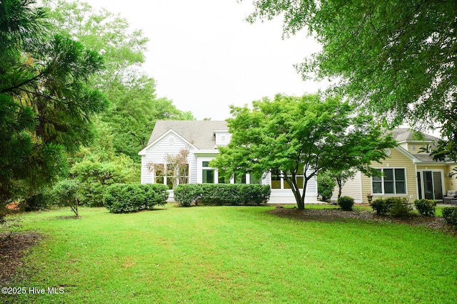 8500 Hammock Dunes Dr, Wilmington, NC 28411 - view of property hidden behind natural elements featuring a front yard
