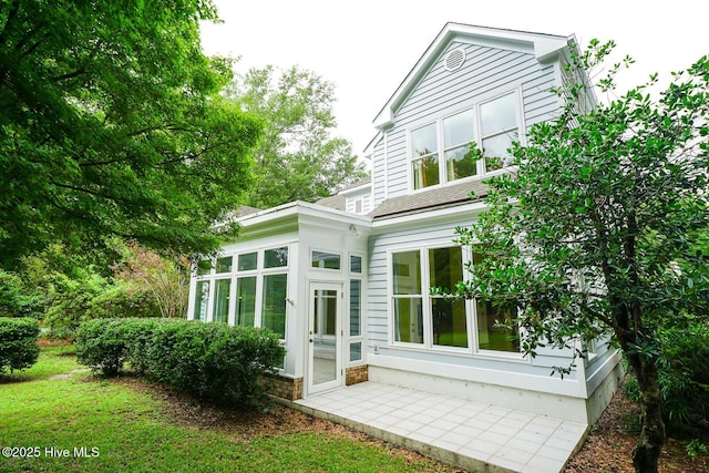 8500 Hammock Dunes Dr, Wilmington, NC 28411 - rear view of house with a sunroom and roof with shingles