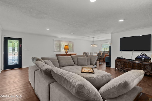 140 One Down St, Southern Pines, NC 28387 - living room featuring a textured ceiling, wood finished floors, recessed lighting, and a chandelier