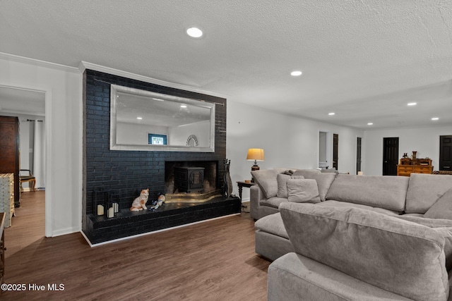 140 One Down St, Southern Pines, NC 28387 - living room with a textured ceiling, wood finished floors, recessed lighting, ornamental molding, and baseboards