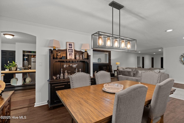 140 One Down St, Southern Pines, NC 28387 - dining space with arched walkways, dark wood finished floors, ornamental molding, recessed lighting, and baseboards
