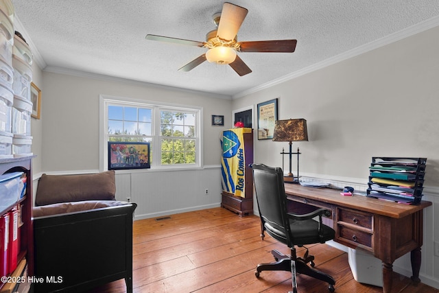 140 One Down St, Southern Pines, NC 28387 - office area featuring light wood-type flooring, a textured ceiling, wainscoting, ceiling fan, and ornamental molding