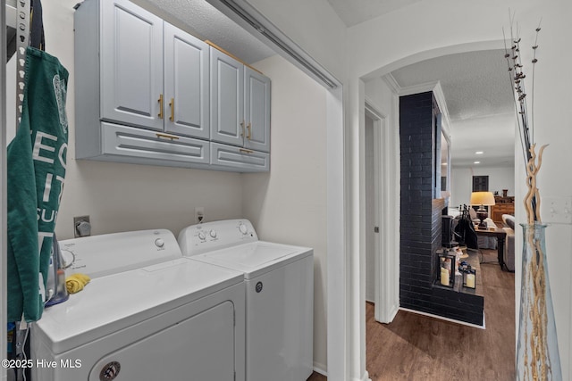 140 One Down St, Southern Pines, NC 28387 - washroom featuring cabinet space, washer and dryer, wood finished floors, and arched walkways