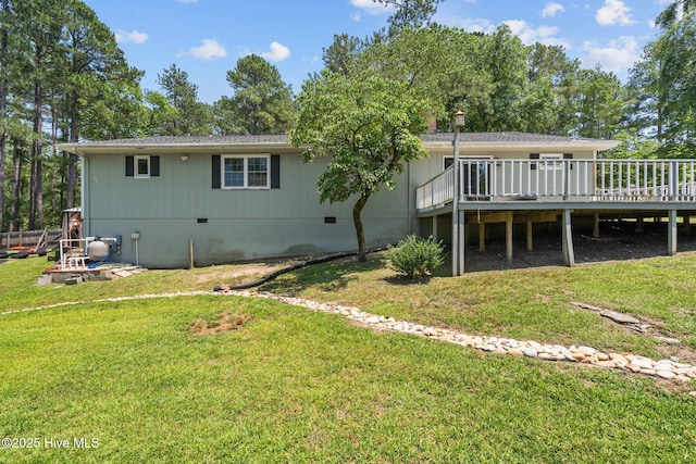 140 One Down St, Southern Pines, NC 28387 - back of property with a deck, crawl space, and a lawn