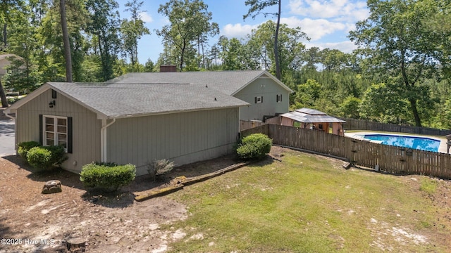 140 One Down St, Southern Pines, NC 28387 - view of property exterior with a shingled roof and a chimney