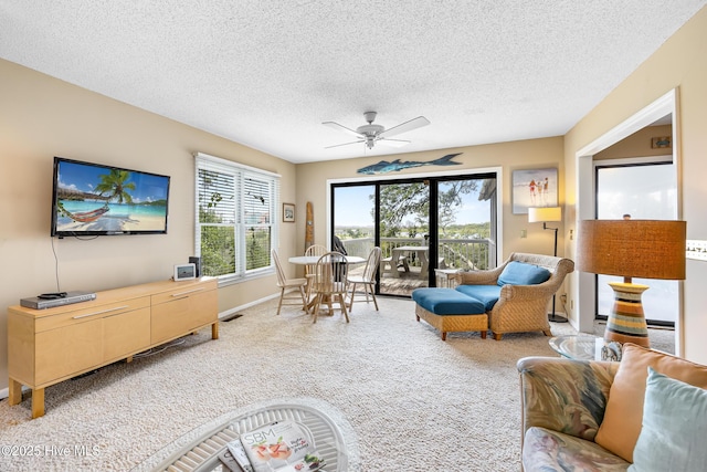 1137 Indigo Cir, Sunset Beach, NC 28468 - carpeted living room with a textured ceiling, ceiling fan, and baseboards