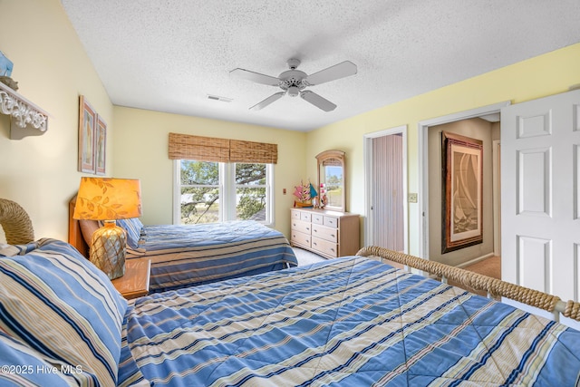 1137 Indigo Cir, Sunset Beach, NC 28468 - carpeted bedroom with a textured ceiling and a ceiling fan