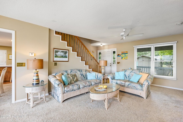 1137 Indigo Cir, Sunset Beach, NC 28468 - carpeted living room with ceiling fan, stairway, a textured ceiling, and baseboards
