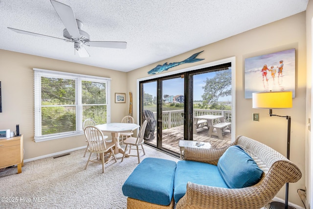 1137 Indigo Cir, Sunset Beach, NC 28468 - dining space with a ceiling fan, baseboards, a textured ceiling, and carpet