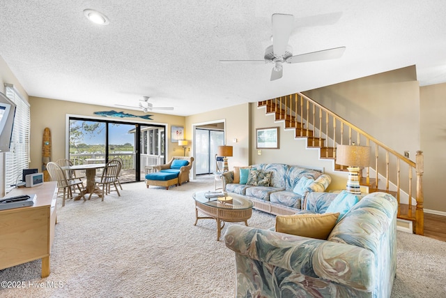 1137 Indigo Cir, Sunset Beach, NC 28468 - living area with carpet flooring, a ceiling fan, stairs, a textured ceiling, and baseboards