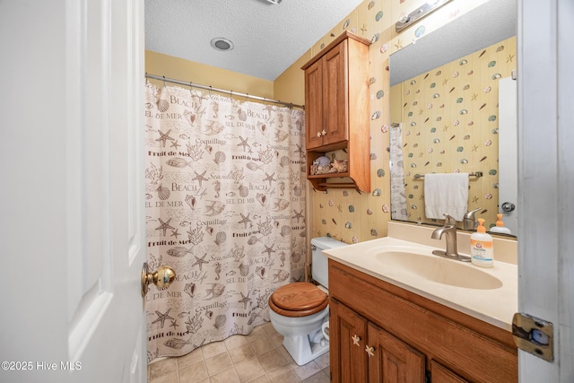 1137 Indigo Cir, Sunset Beach, NC 28468 - full bath with toilet, a textured ceiling, vanity, wallpapered walls, and tile patterned floors