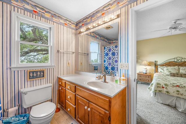 1137 Indigo Cir, Sunset Beach, NC 28468 - bathroom featuring wallpapered walls, vanity, ensuite bath, toilet, and a ceiling fan