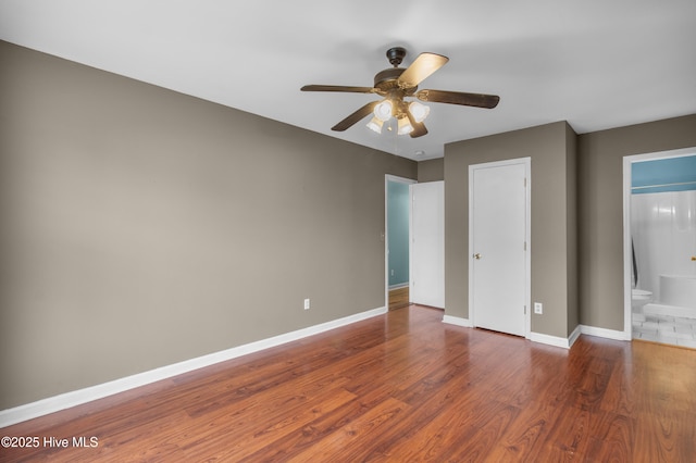 117 S 13th St, Wilmington, NC 28401 - unfurnished bedroom with wood finished floors, ensuite bathroom, and ceiling fan