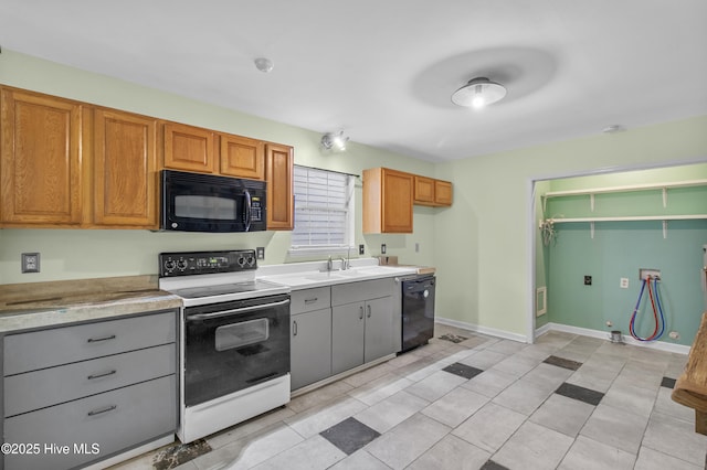 117 S 13th St, Wilmington, NC 28401 - kitchen featuring black appliances, a sink, light countertops, and baseboards