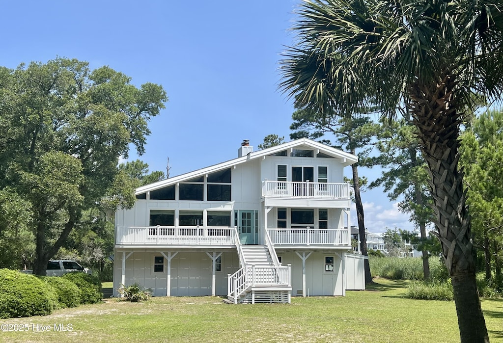 229 Chimney Ln, Wilmington, NC 28409 - back of house with a yard, a balcony, stairway, and a chimney