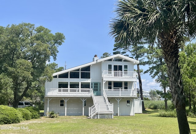 229 Chimney Ln, Wilmington, NC 28409 - back of house with a yard, a balcony, stairway, and a chimney