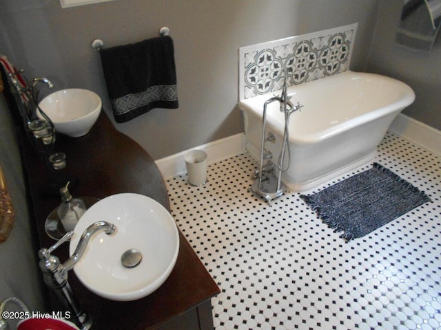 601 Saint Patrick St, Tarboro, NC 27886 - full bath with a soaking tub, baseboards, and vanity