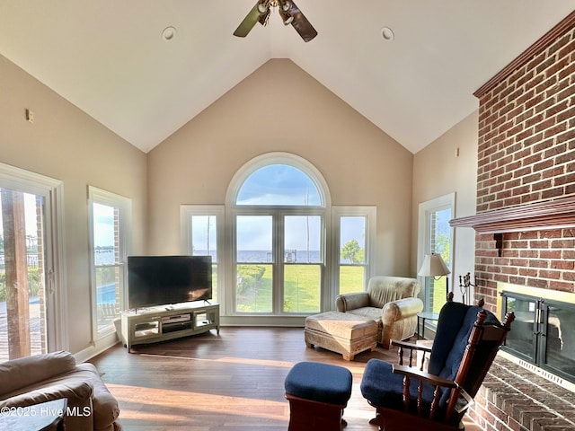 141 Baybreeze Dr, Shiloh, NC 27974 - living room with a ceiling fan, wood finished floors, a brick fireplace, and high vaulted ceiling