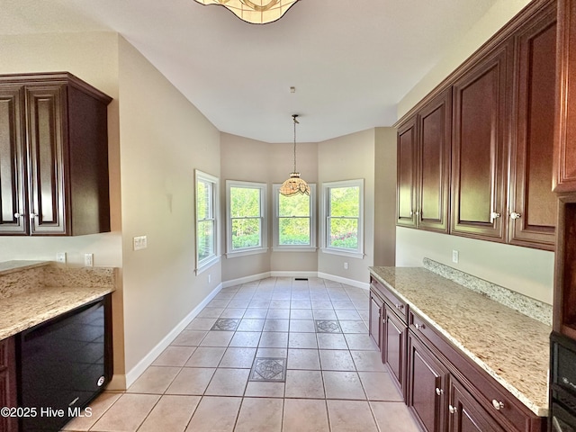 141 Baybreeze Dr, Shiloh, NC 27974 - kitchen featuring light tile patterned floors, baseboards, light stone counters, and hanging light fixtures